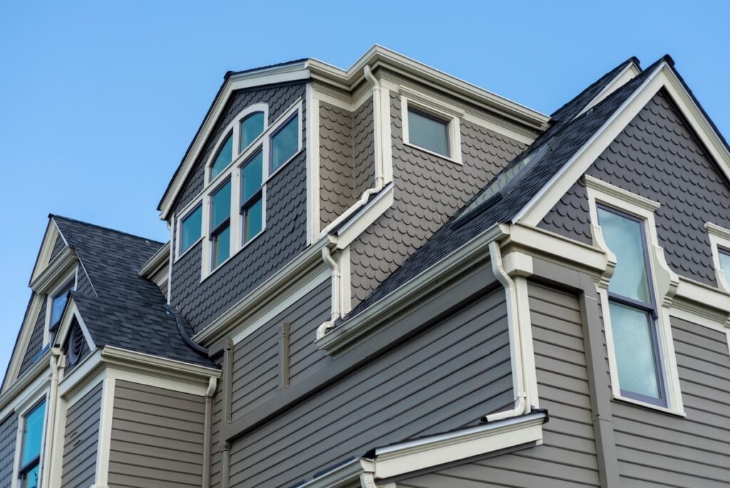 Large historic home under blue sky how to measure a roof for shingles