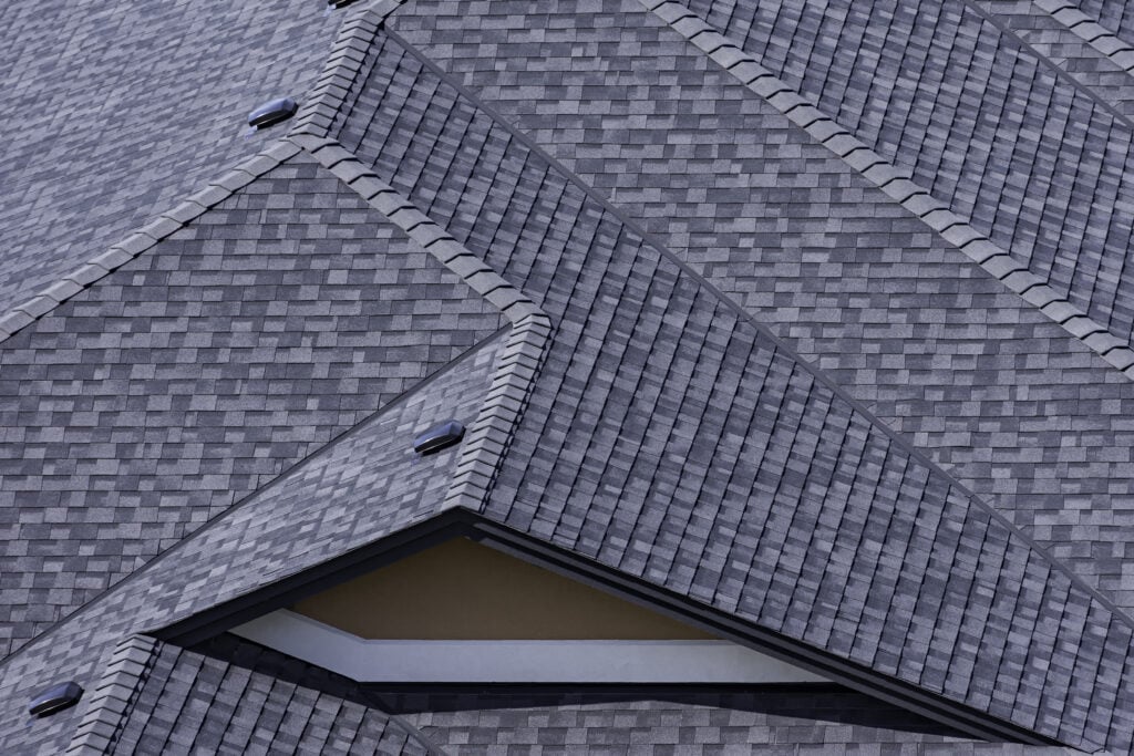 Rooftop in a newly constructed subdivision in Kelowna British Columbia Canada showing asphalt shingles and multiple roof lines