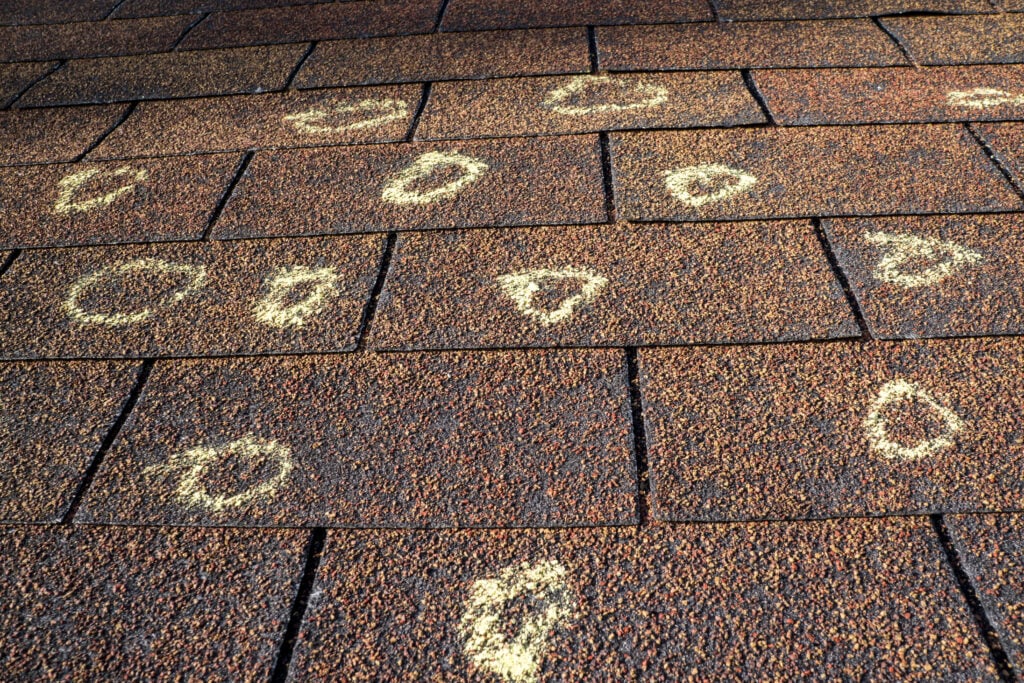Insurance adjuster marked the hail damage on a insureds roof.