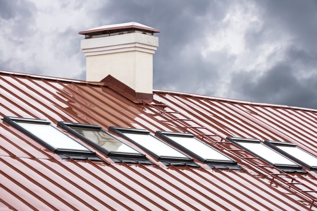 new red metal roof with skylights and chimney