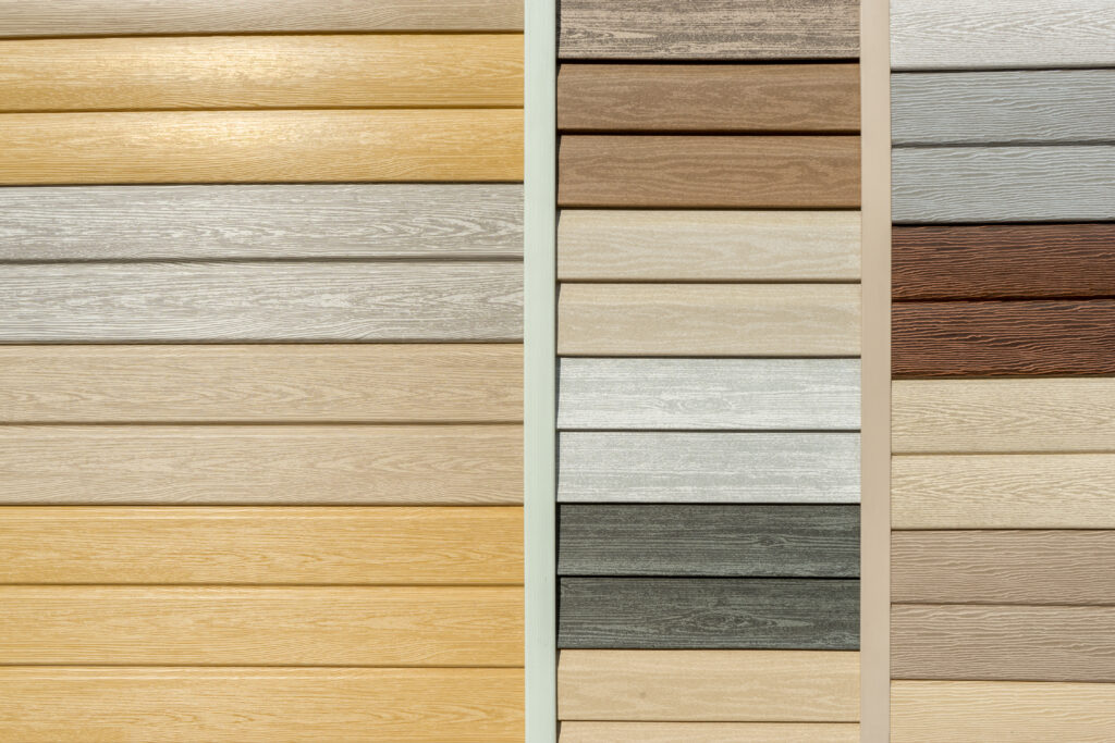 Vinyl siding colors with imitation wood texture in bright palette of colors. Plastic wall covering for exterior decoration of house. Abstract background for your design with copy space and place for text.