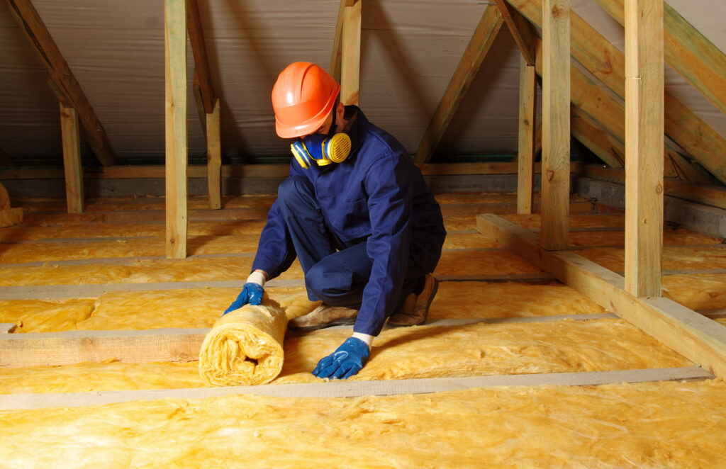 Worker insulate the attic with mineral wool