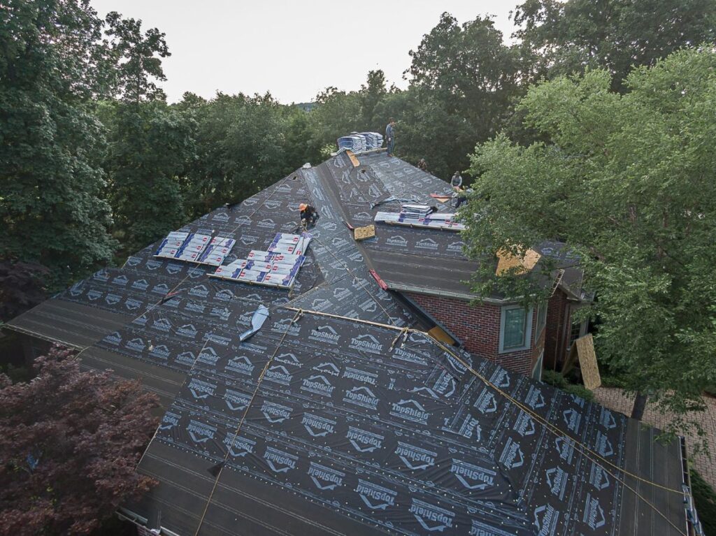 roof granule loss Armour Construction workers repairing