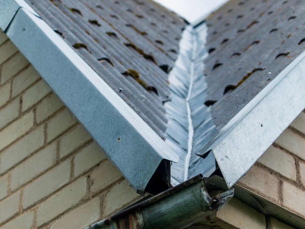 roof valley leak metallic piece dark asphalt shingles