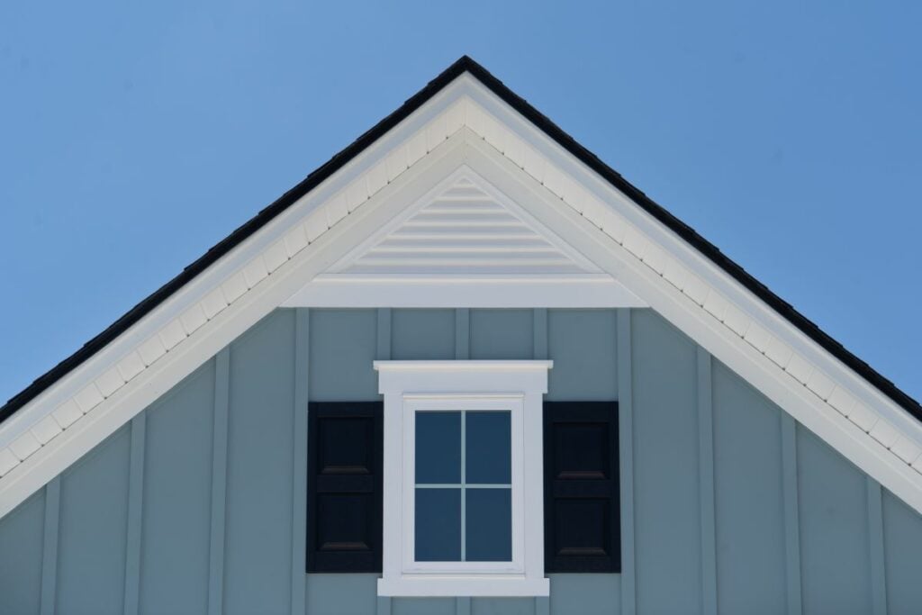 board and batten vinyl siding blue and white house small window