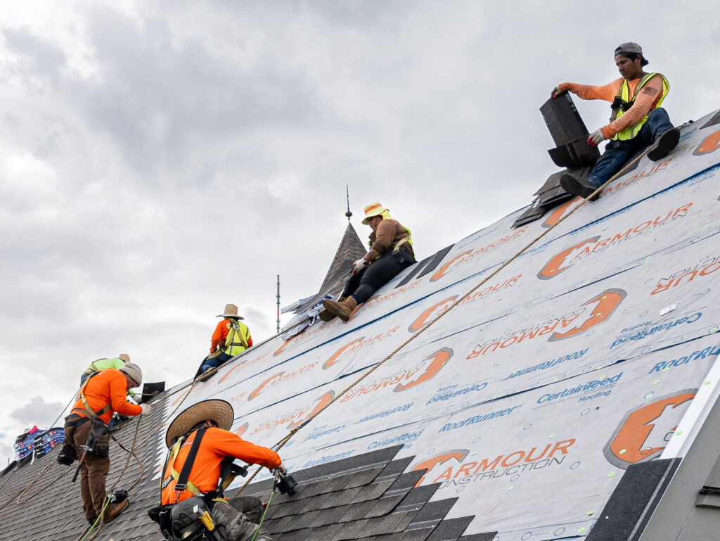 synthetic roof underlayment vs felt workers installing shingles