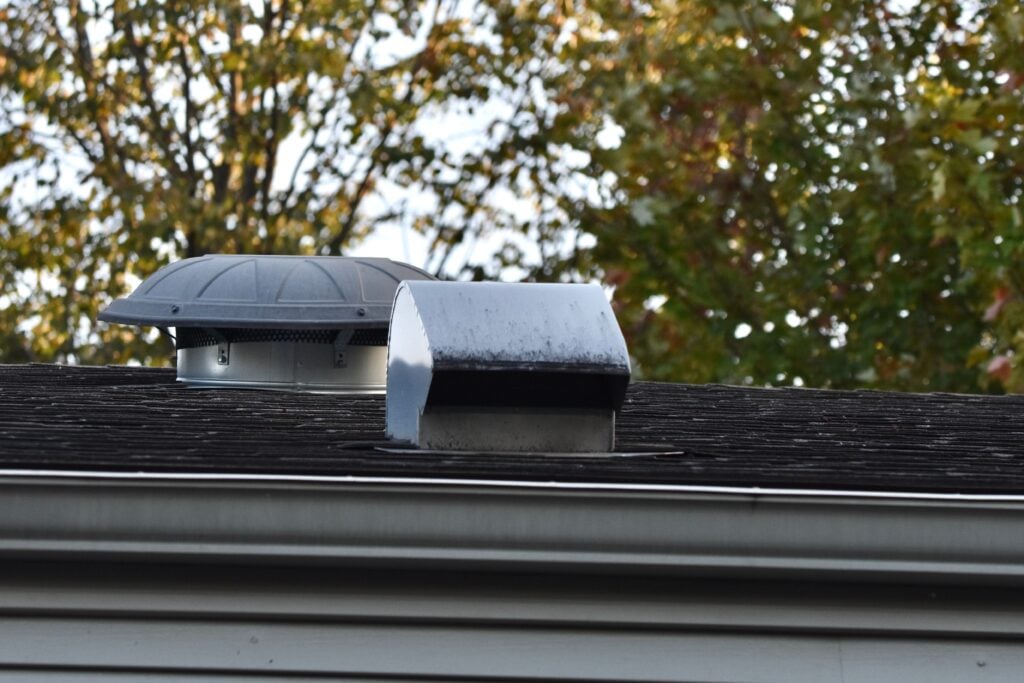 attic ventilation vents on top of shingles roof