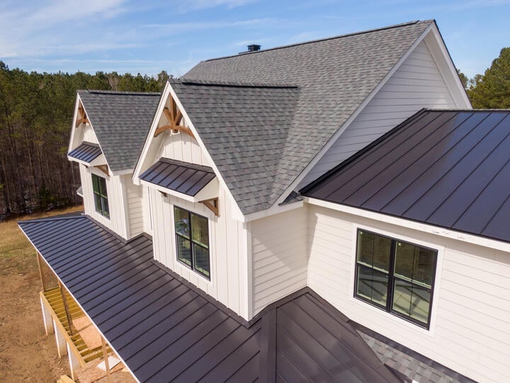 grey shingles roof and metal seam roof