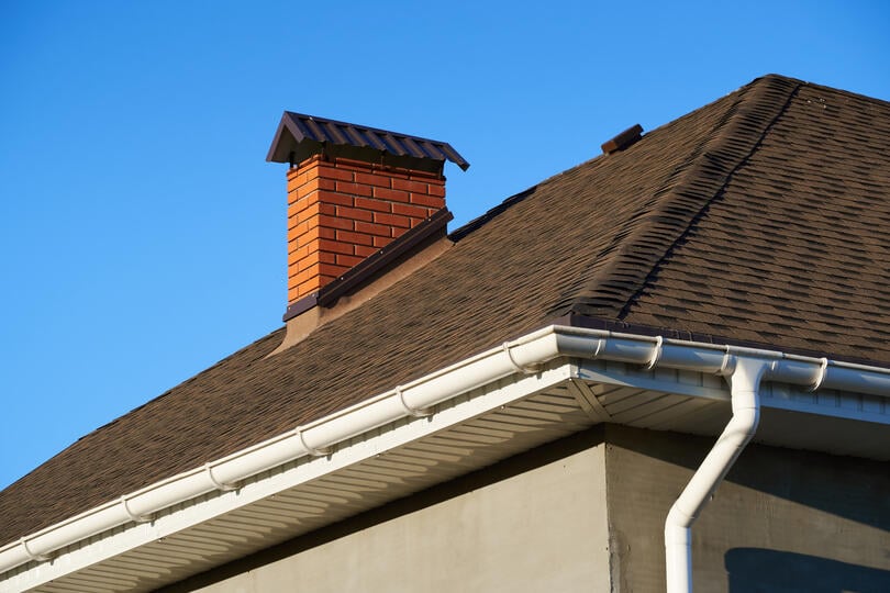 brown shingles orange brick chimney