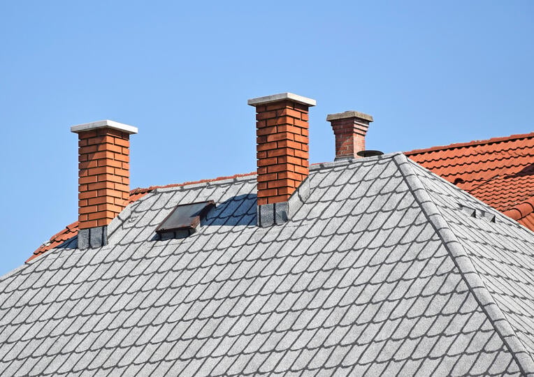 grey shingles roof with small cricket
