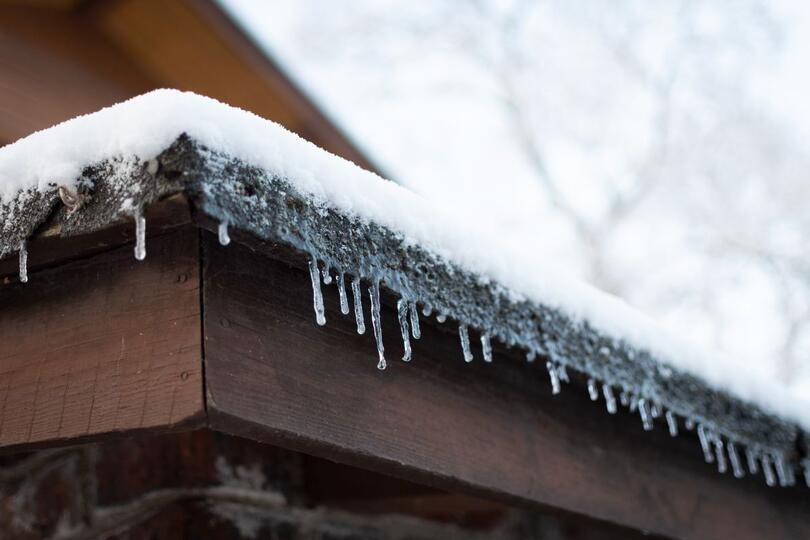 small ice dam and snow on top of roof
